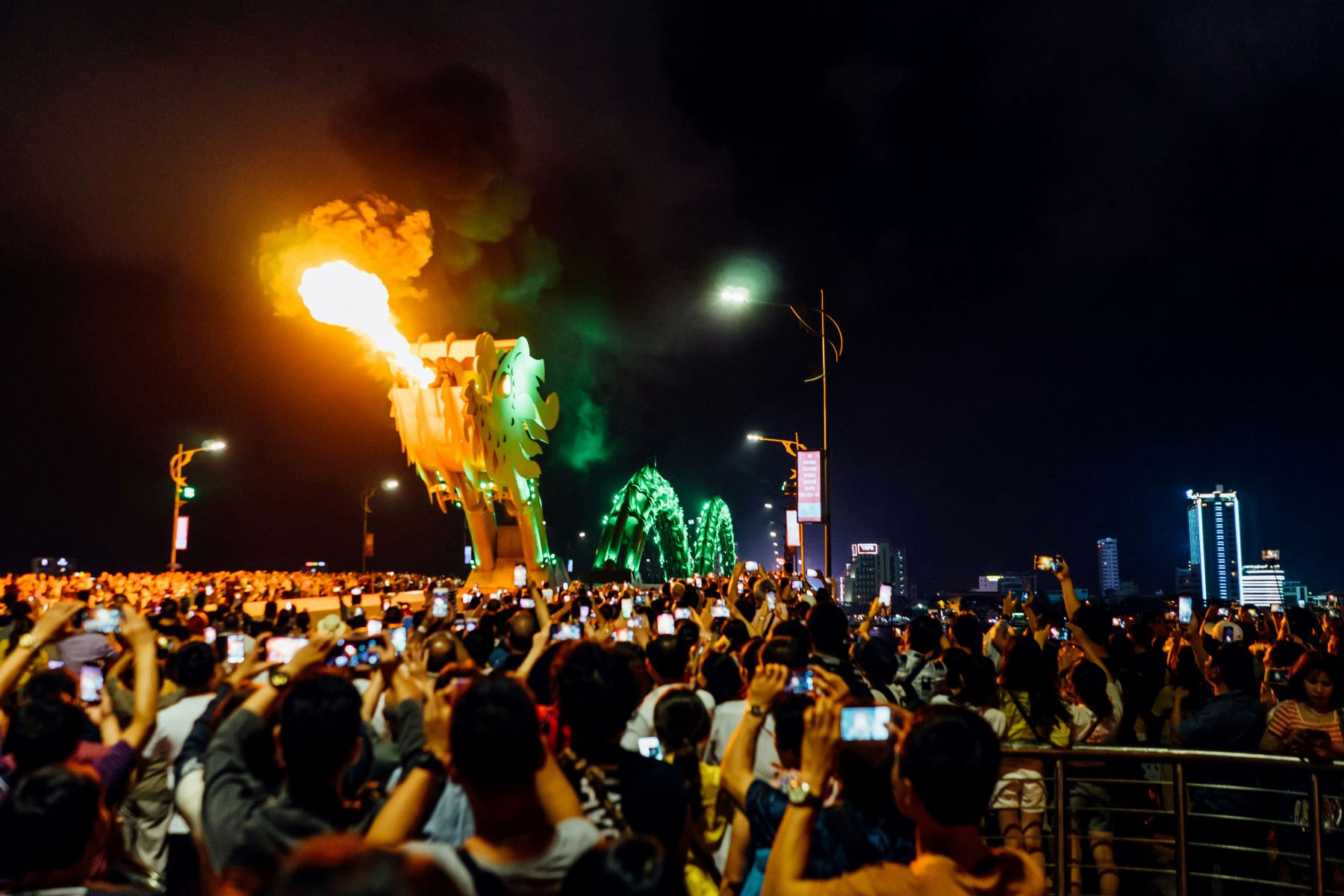 People watching fire from the tower at nighttime